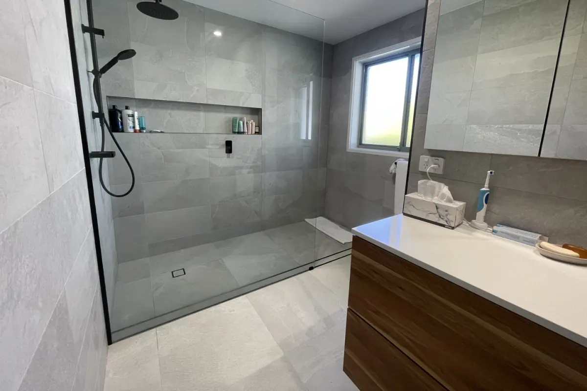 Tiled wall and floor in a renovated bathroom, Canberra home