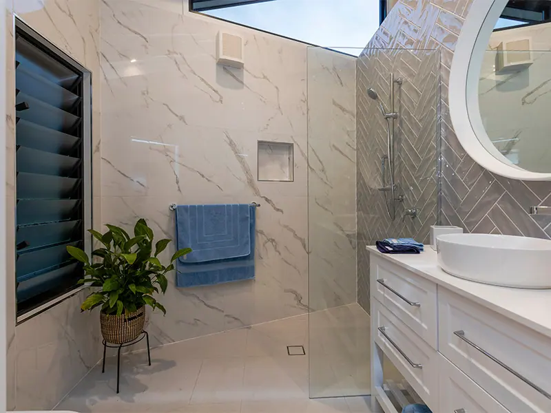 Compact renovated bathroom with a wall-hung vanity and mirror, Canberra home