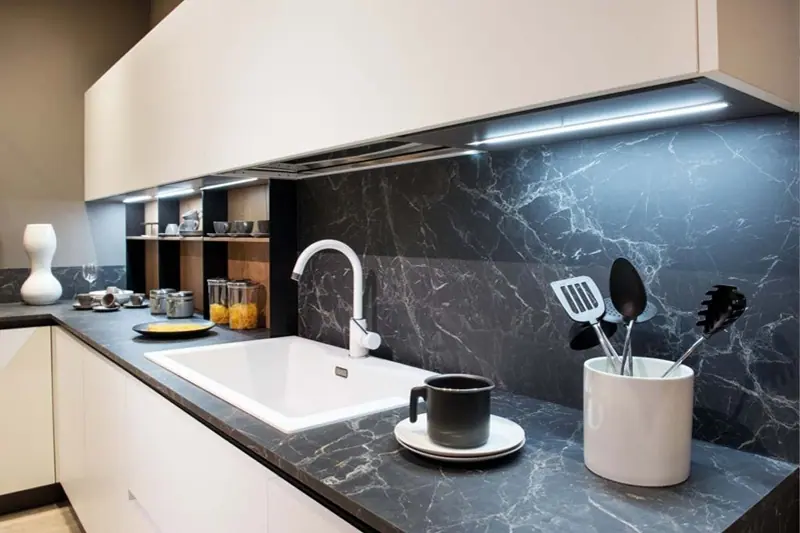 Tiled kitchen wall and floor behind a benchtop, Canberra home