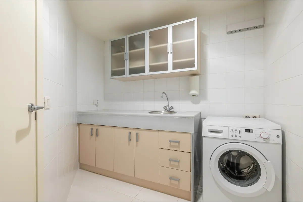 Laundry bench and cabinetry with a washer and dryer side by side, Canberra home
