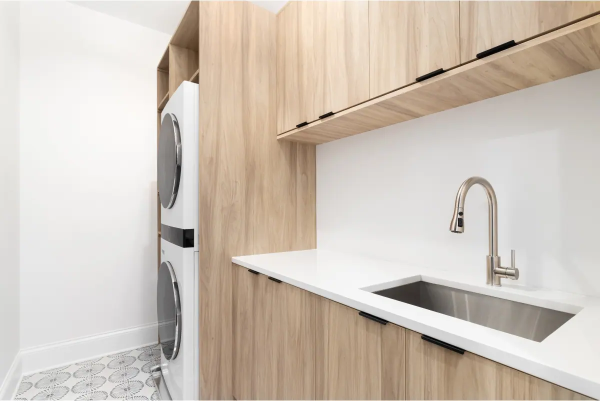 Laundry storage cupboards and a tiled floor after renovation, Canberra home